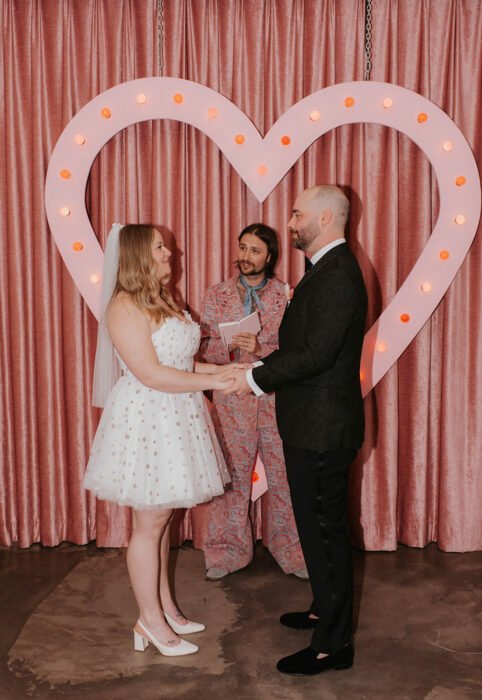 Aly & Matt exchanging vows at Sure Thing Chapel, Downtown Las Vegas. Captured by Brittany Lo Photo.