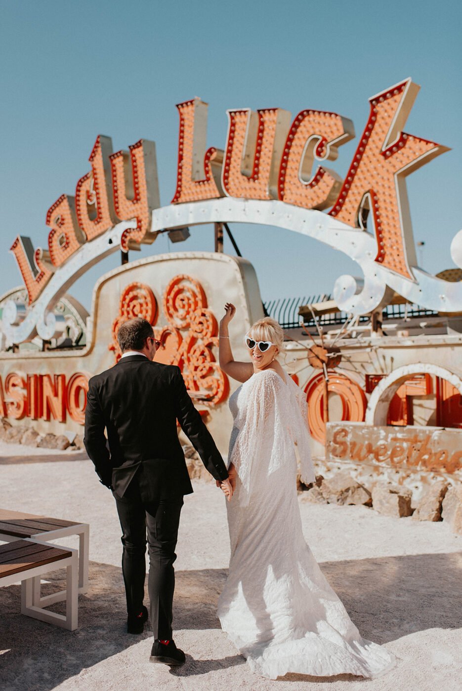 Neon Museum wedding photographer Las Vegas — couple among vintage neon signs