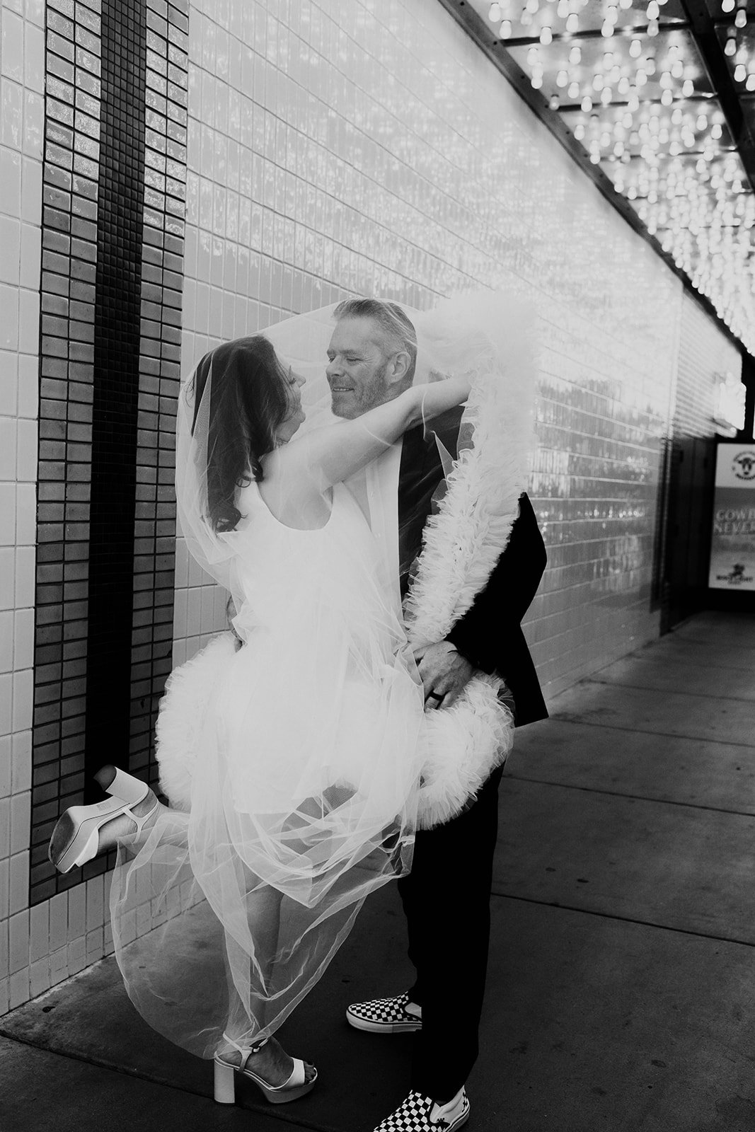 a downtown las vegas little white chapel elopement with neon lights at the plaza hotel carousel bar